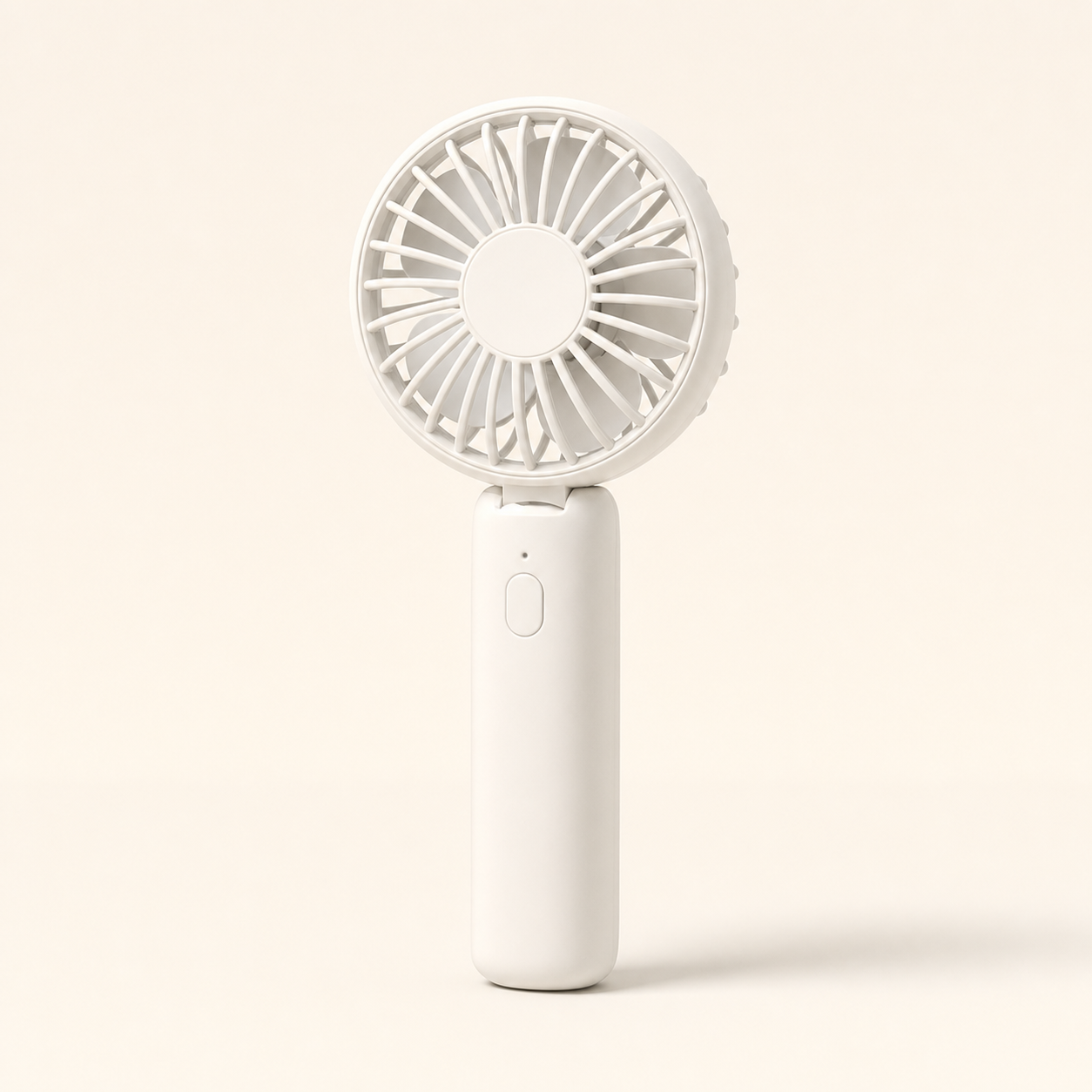 Portable mini fan held in hand outdoors