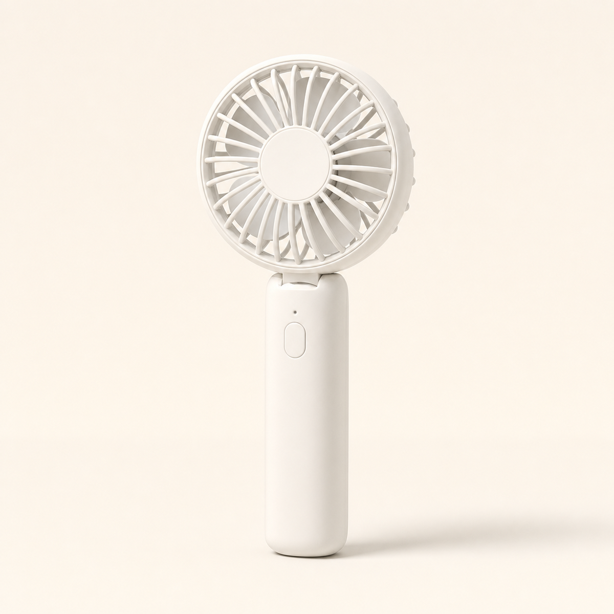 Portable mini fan held in hand outdoors