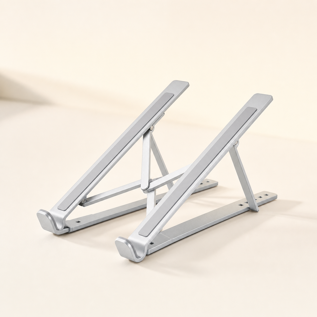 Foldable aluminium laptop stand on a desk